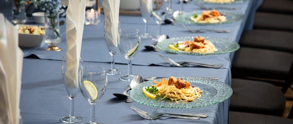 A well-appointed bar mitzvah table setting featuring clear dishware